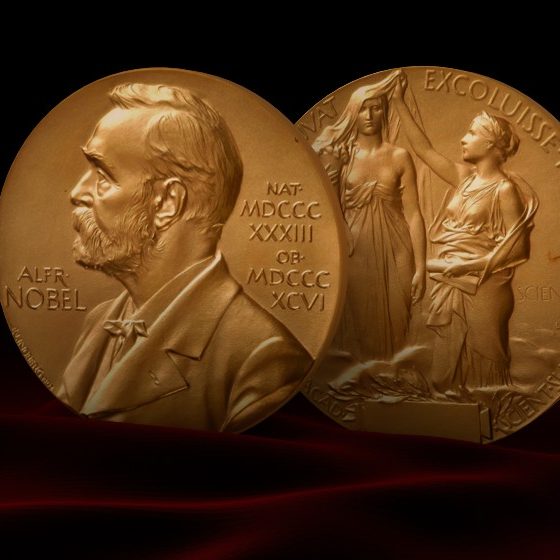 Nobel Prize Medal standing on a platform. Red and black background | 2 journalists win Peace Prize at just the right time | featured