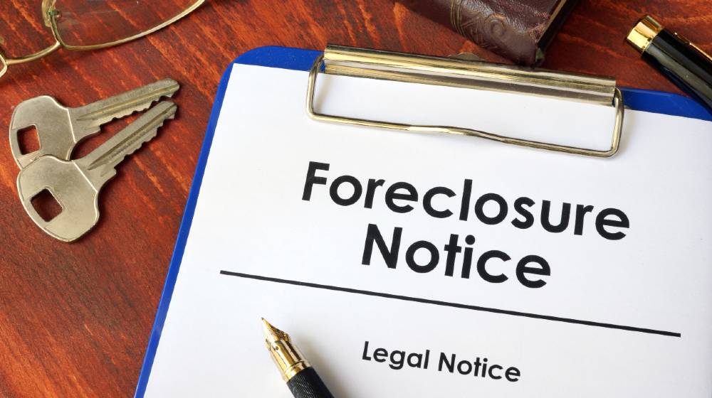 Paper with words Foreclosure Notice on a wooden surface | What Every Person Facing Foreclosure Should Know | featured