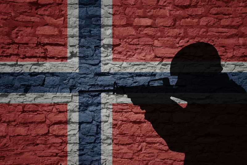 Soldier silhouette on the old brick wall with flag of norway country-CNN 5 Things
