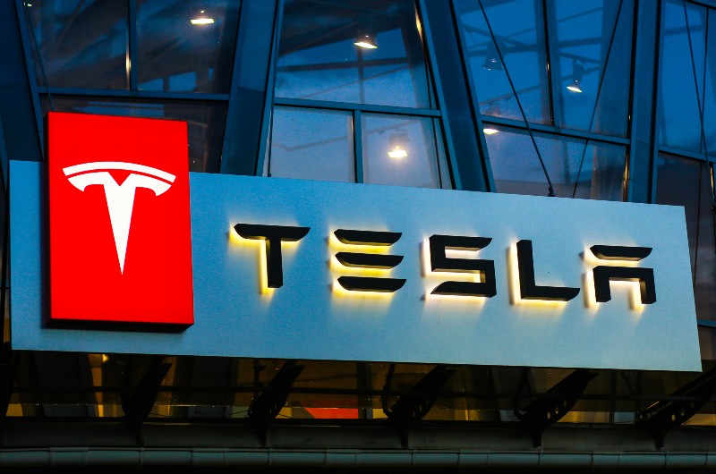 Tesla sign on the building on car sales-Tesla Ex-Worker