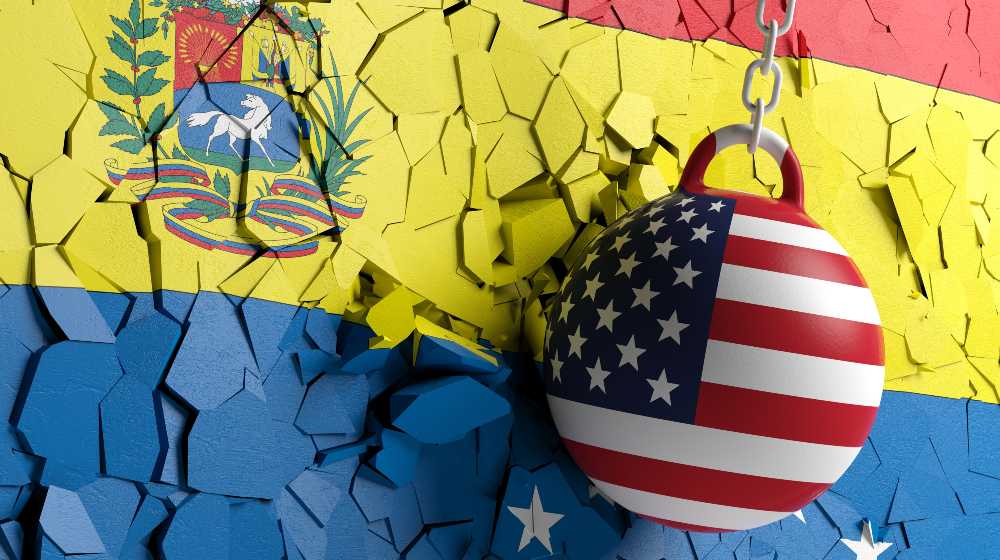 US of America flag wrecking ball breaking a Venezuelan flag wall | US in No Position to Dictate Rules to Sovereign States | featured
