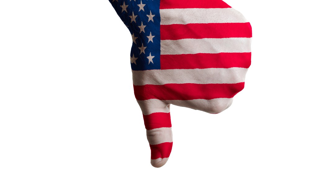 Hand with thumb down gesture in colored us national flag as symbol of negative political | Low Joe! Biden’s Popularity Rating Hits A New Low of 36% | featured