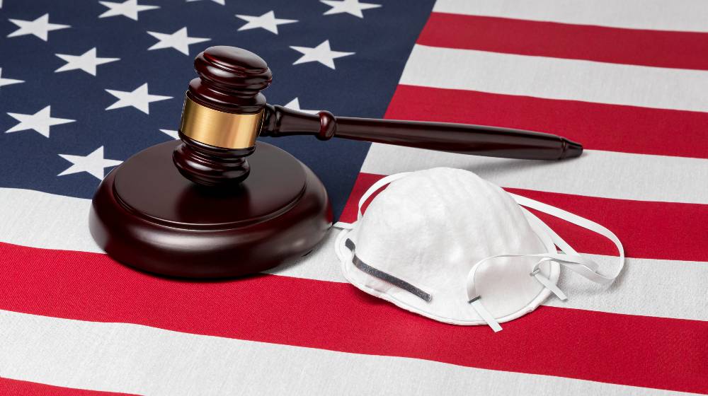 N95 face mask, gavel and United States of America flag | Rep. Taylor Greene Fined $48k for Defying House Mask Rules | featured