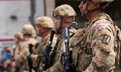 National Guard troops stand along the street | Oklahoma National Guard Refuses Vaccine Mandate | featured