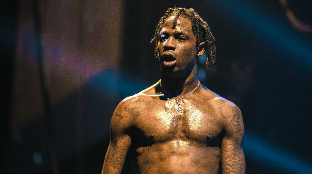 Travis Scott performing live music show concert on night club stage | 400 Victims Sue Travis Scott, AstroWorld Organizers For $750M | featured