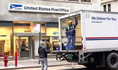 USPS postman on a mail delivery truck in New York | Postmaster Says US Postal Service Ready for the Holiday Rush | featured