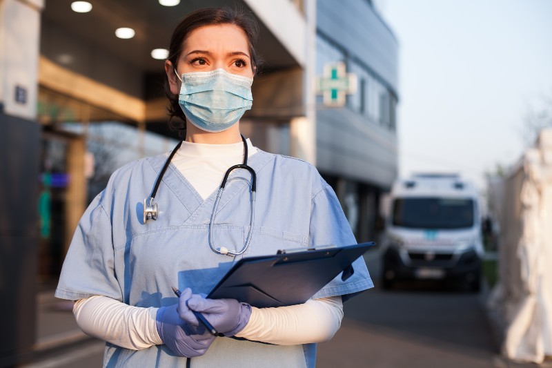 Young female EMS key worker doctor in front of healthcare-Healthcare Workers