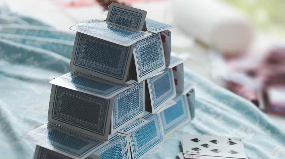 white and blue game cards on blue and white table | Kevin Spacey Ordered to Pay $31M To House of Cards Production Firm | featured