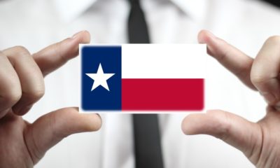 Businessman holding a business card with Texas State Flag | Texas Beats California As The Quitting Capital of the US | featured