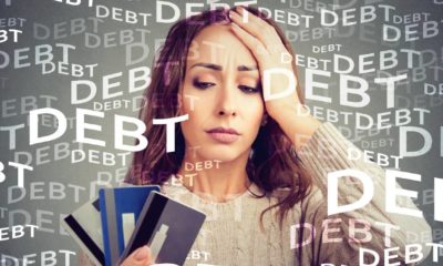 Concerned woman looking at many credit cards scared with huge amount of debt | How to Quickly Crush Credit Card Debt | featured
