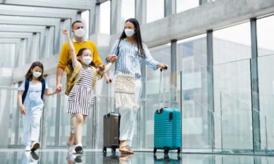 Family with two children going on holiday, wearing face masks at the airport | CNN 5 Things