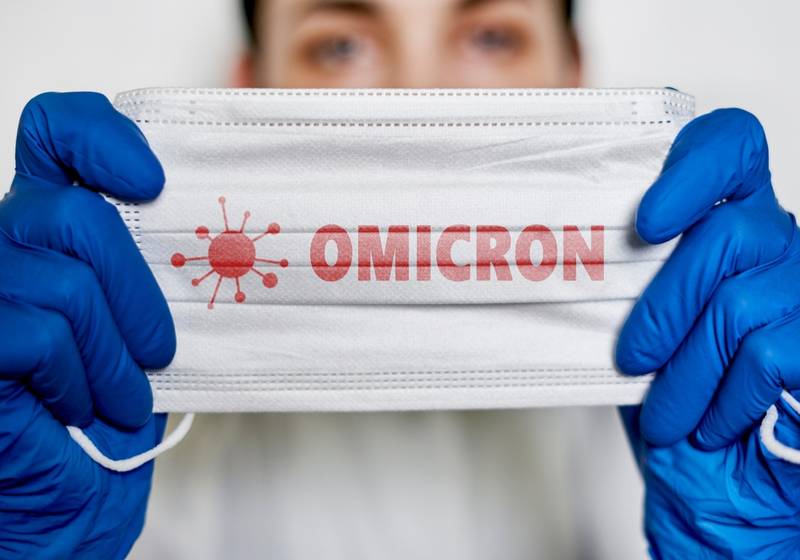 Female doctor holds a face mask with - Omicron variant | COVID Omicron