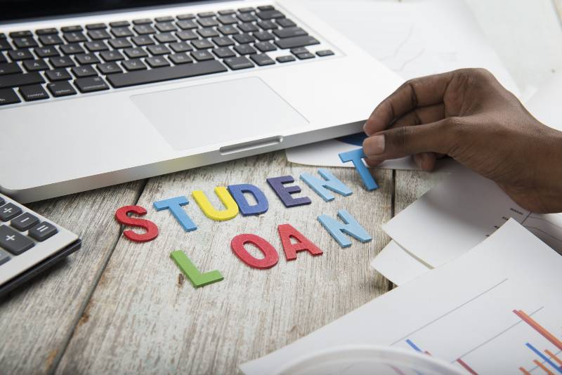 Hand arrange wood letters as student Loan word | Student Loan