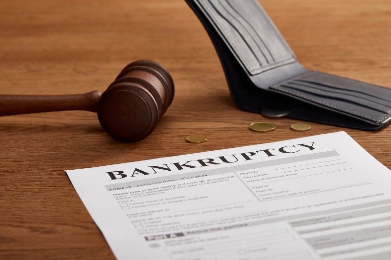bankruptcy form with wooden gavel, coins and wallet | Bankruptcy