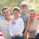 beautiful modern american family with USA flag outdoors | 18% of American Families Have Married Parents With Children | featured