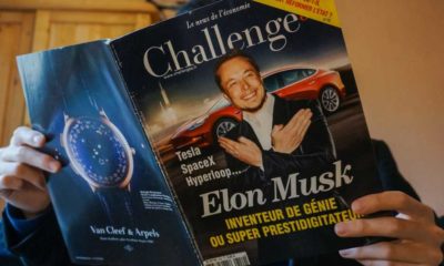 A man reads an issue of the French economic newspaper Challenges showing the businessman Elon Musk in front of a Tesla | Biden’s Tweet About US Auto Manufacturing Ignores Tesla, Elon Musk | featured