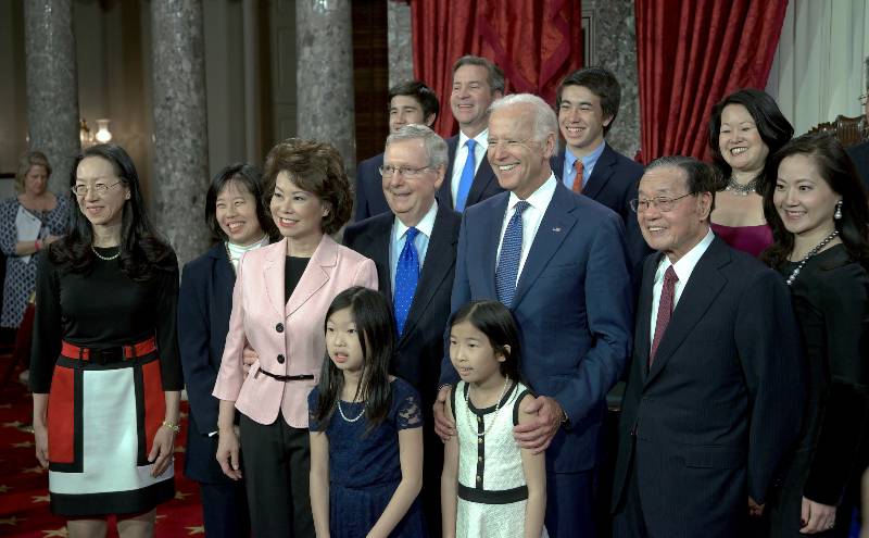 Elaine Chao pose for pictures with their families and Vice President Joe Biden after being sworn | New Book Claims Biden Family Earned $31 Million While Joe Was VP