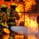 Fire brigade people extinguishing the fire, Fire brigade spreading water | New York’s Worst Fire Disaster in 30 Years Claims 19 Lives | featured