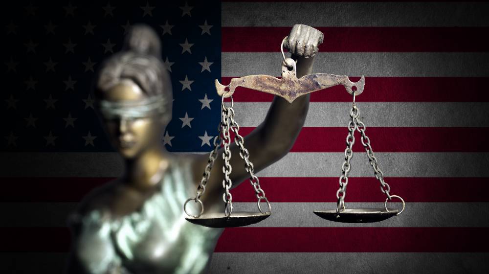 Lady justice with U.S flag background | Supreme Court Strikes Down Biden’s Vaccine Mandate for Companies | featured