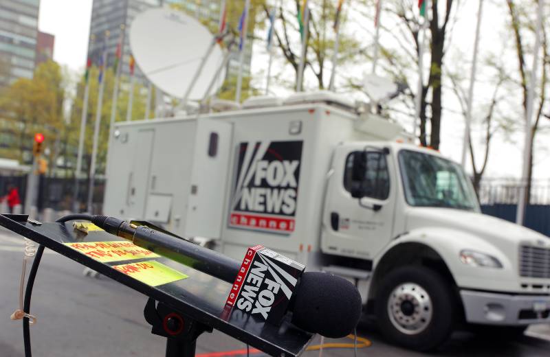 Microphone of a Fox News TV Reporter in Front of a Broadcasting Truck | Biden Caught Swearing At Fox News Reporter Peter Doocy | featured