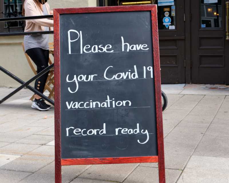 Sign at entrance of restaurant requesting patron to have their Proof of Vaccination ready | Vaccine Mandate for Companies