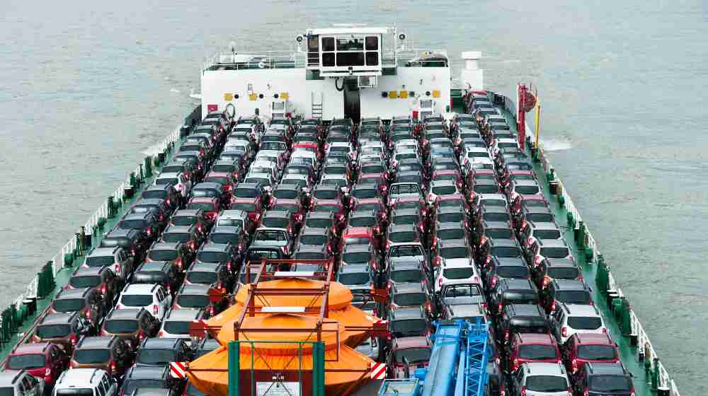 Boat carries a lot of cars to market | Cargo Ship Carrying Porsches Are Burning In The Atlantic Ocean | featured