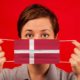 Coronavirus COVID-19 in Denmark. Woman in medical protective mask | Denmark Removes All COVID Restrictions Beginning February 1 | featured