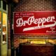 Dr.Pepper red sign on a brick wall | Sen. Kennedy: More People Trust Dr. Pepper Than Dr. Fauci | featured