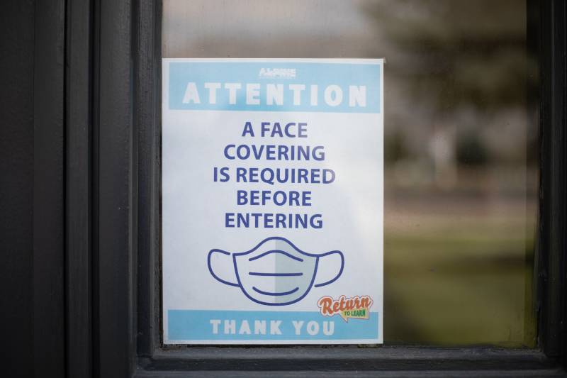 Exterior door sign at Mountain View High School, part of Alpine School District, reminds all to wear face coverings | US Population Has More Immunity Now 