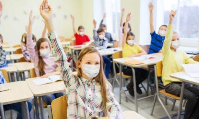 education, pandemic and health concept - group of students wearing face protective medical mask | Dr. Scott Gottlieb Wants To Drop School Mask Mandates | featured