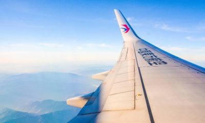 China Eastern Airplane's wing over beautiful blue sky and mountain ranges | Boeing 737-800 Crashes in China, 132 Presumed Dead | featured