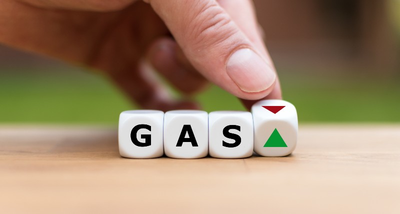 Hand is turning a dice and changes the direction of an arrow symbolizing that the price for gas is changing the trend and goes up | McConnells Calls Out White House’s ‘Revisionist HIstory’ On High Gas Prices