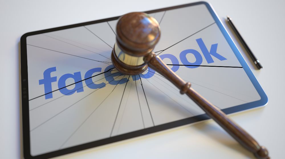 Logo of facebook on the tablet computer screen hit by judge's gavel-Less Time on Facebook-SS-Featured