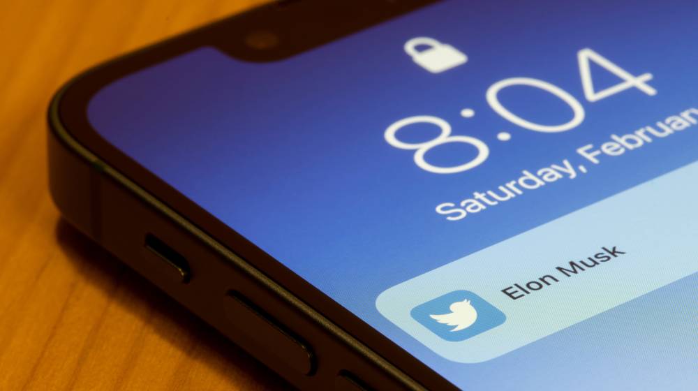 Notification showing a new tweet from Elon Musk is seen on the lock screen of an iPhone | Elon Musk Seriously Considering Making New Social Media App | featured