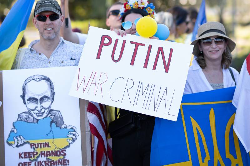 Stand with Ukraine. Protest against the war and russian armed aggressive Vladimir Putin politic | Biden Thinks Putin Is A ‘War Criminal’