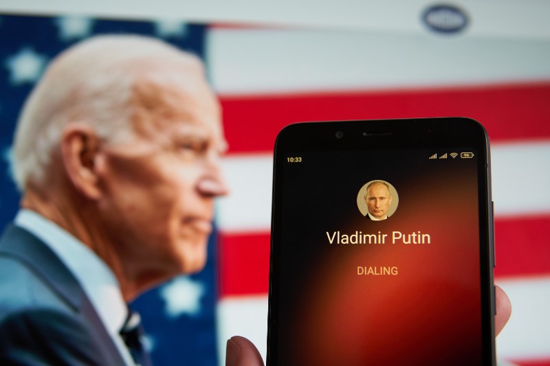 The smartphone with Vladimir Putin contact seen on it's screen and Joe Biden seen | Russia Imposes Sanctions on US President and Other Democrats