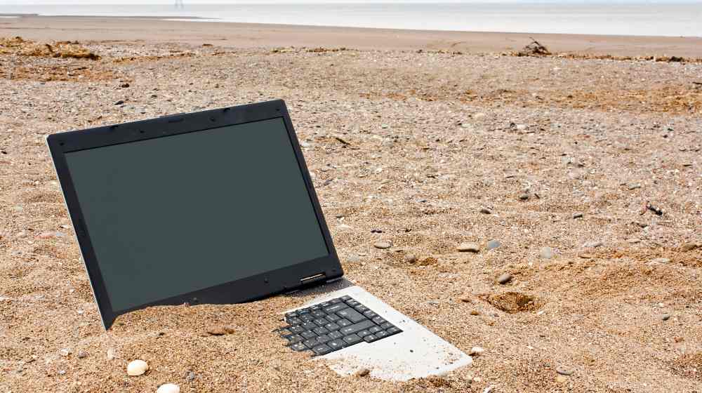 old or obsolete unwanted laptop on the beach | NY Times Confirms Existence of the Hunter Biden Laptop | featured