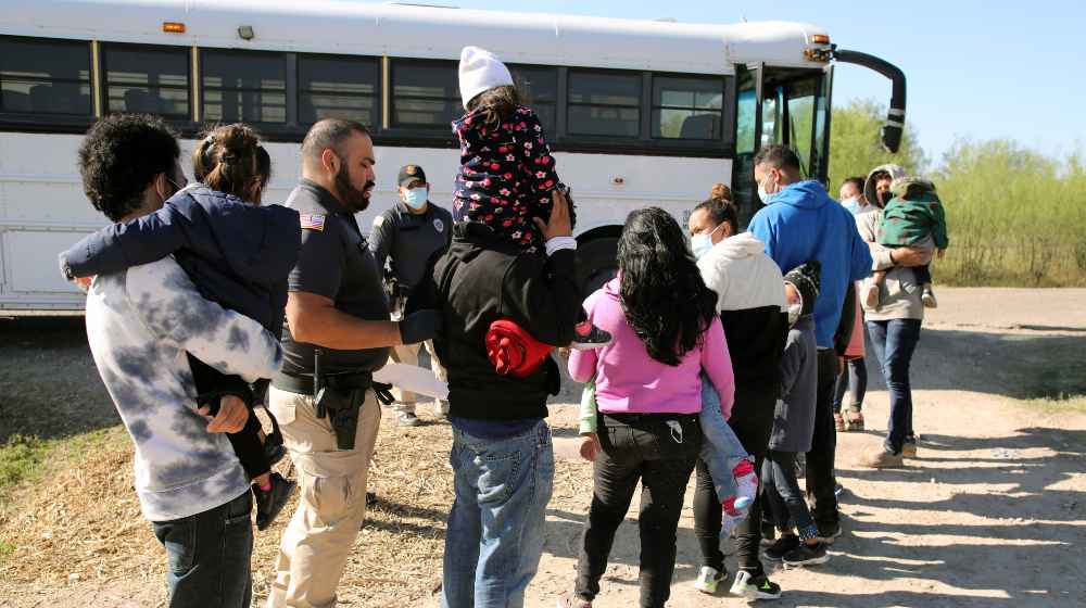 A group of Central American families being transported to a processing center | DeSantis Warns Migrant Bus Passengers: Don’t Go To Florida | featured