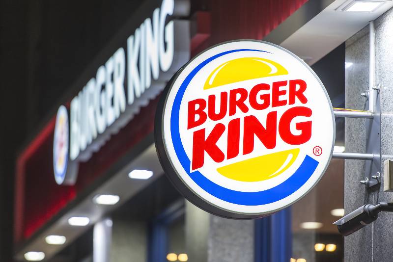 Burger King restaurant exterior - sign near the main entrance | Burger King Faces Lawsuit For Misleading Whopper Sizes in Ads