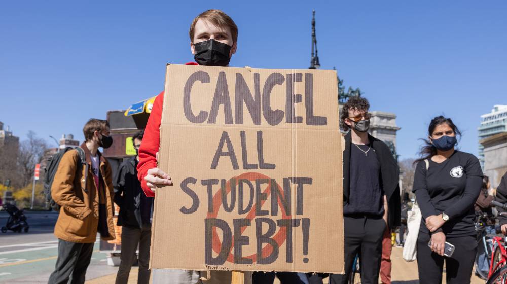 Demonstrators protest near Grand Army Plaza during a rally to cancel student loan debts | Will Biden Cancel Student Debt? Deluded Schumer Thinks Yes | featured