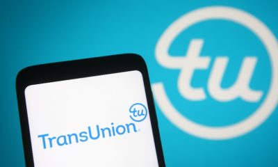In this photo illustration TransUnion Holding Company, Inc | CFPB Sues TransUnion for Deceptive Marketing Practices | featured