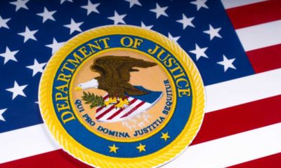 The symbol of the United States Department of Justice portrayed with the US flag - DOJ -ss