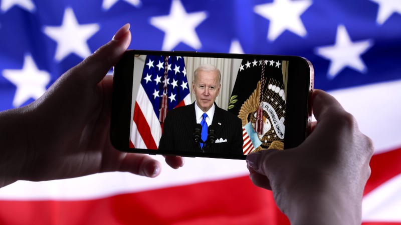 Watching online speech of President Joe Biden on smartphone | Gallup Poll Tracks Biden Approval Among Young Voters 