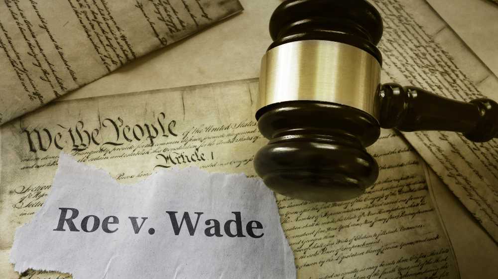 Roe v Wade news headline with gavel on a copy of the United States Constitution | SCOTUS to Overturn Roe v. Wade, Finally End Abortion Rights | featured