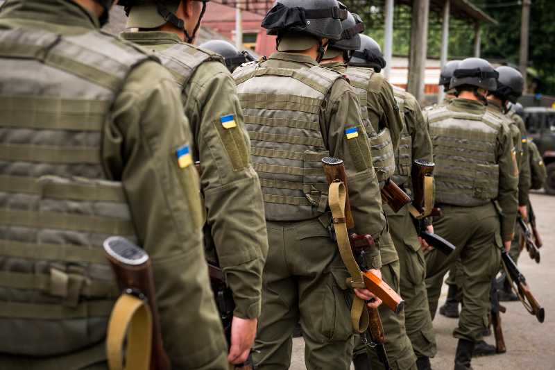 A Kalashnikov rifle in the hands of the military. War in Ukraine | Ukraine Reclaims Town, US Tornado and Flood Watches, Disney Walkout & More