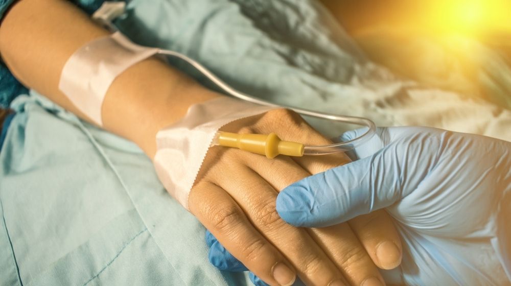 A doctor holding the hand of a cancer patient-'Saved by the Bell' star Dustin Diamond Dies at 44 from Lung Cancer-ss-Featured