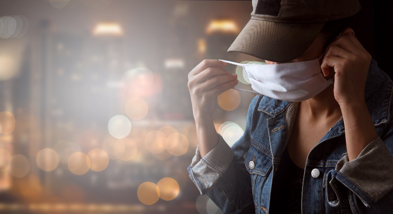 A tourist wearing a mask isolated on city-CNN 5 Things