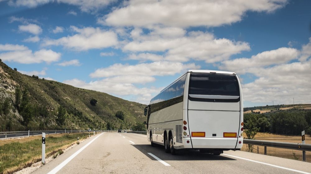 Long Haul Bus for Tourists Drives through the Open Roads | While Other Businesses Reopen, Tour Bus Industry Continues to Suffer | Featured