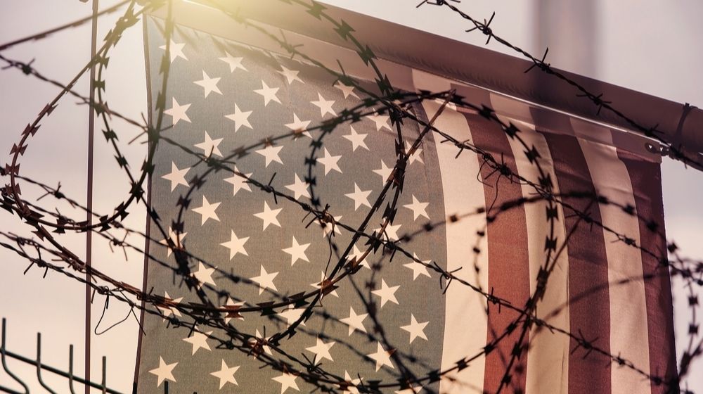 American Flag and Barbed Wire | Former Trump Aide Steve Bannon Arrested in Donor Fraud Case | Featured