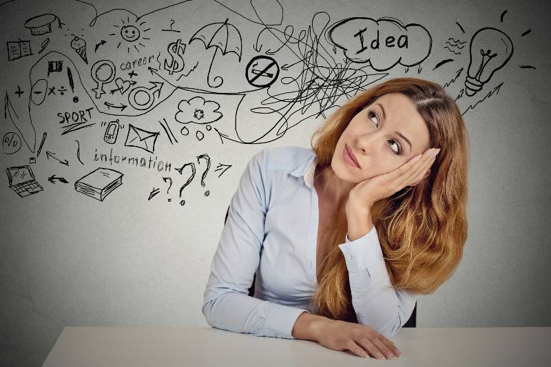 Business woman sitting at table has many ideas | Why Do Perceptions and Priorities Differ Among Americans? 5 Considerations